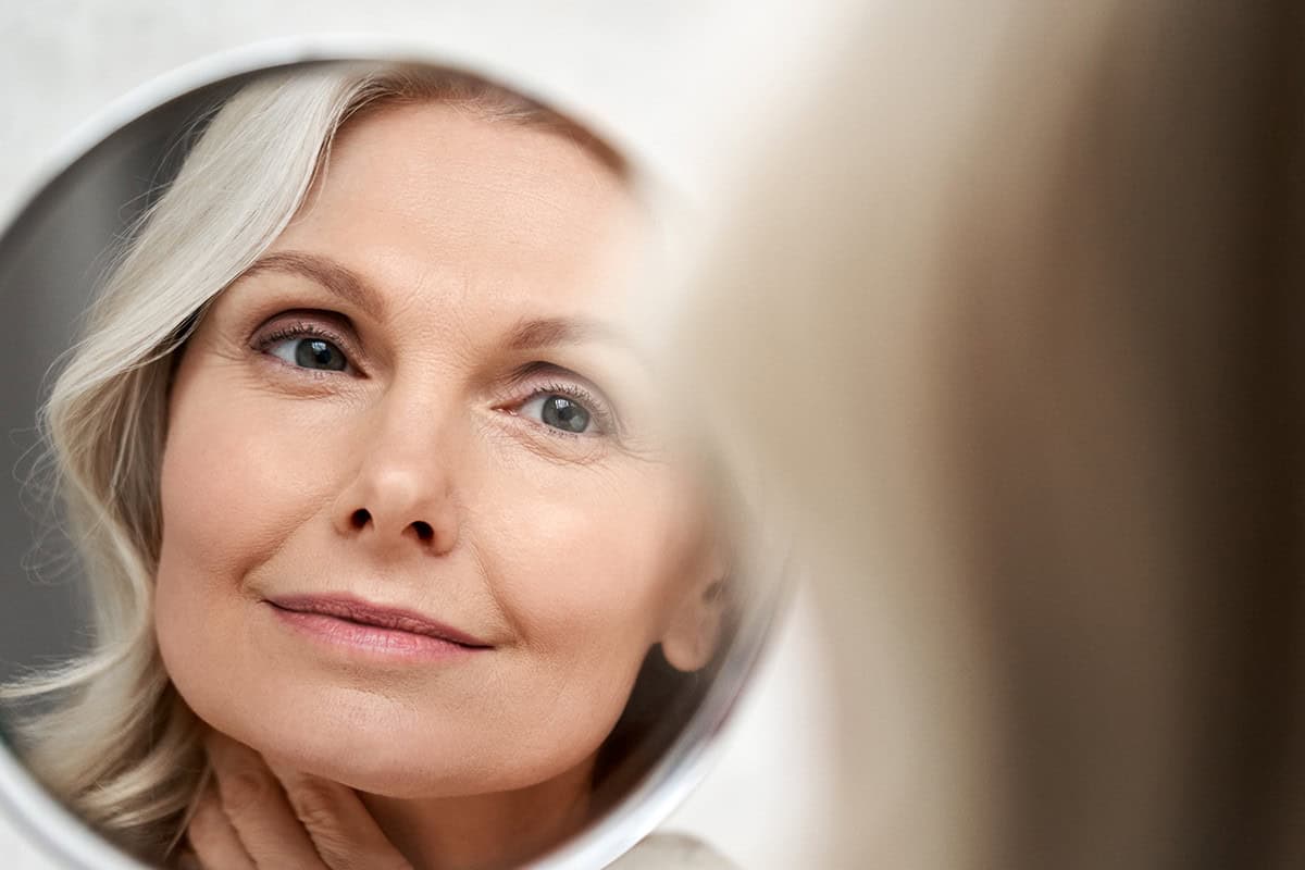 woman looking in mirror