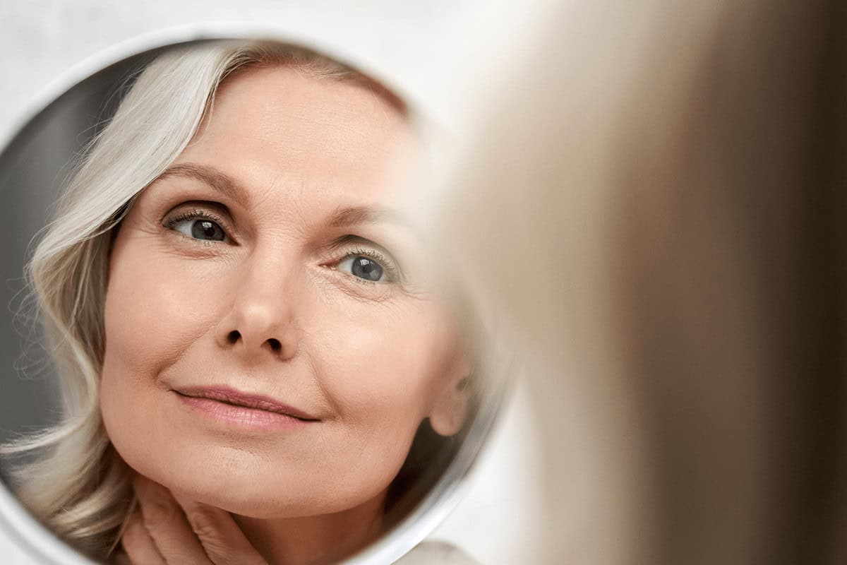 woman looking in mirror